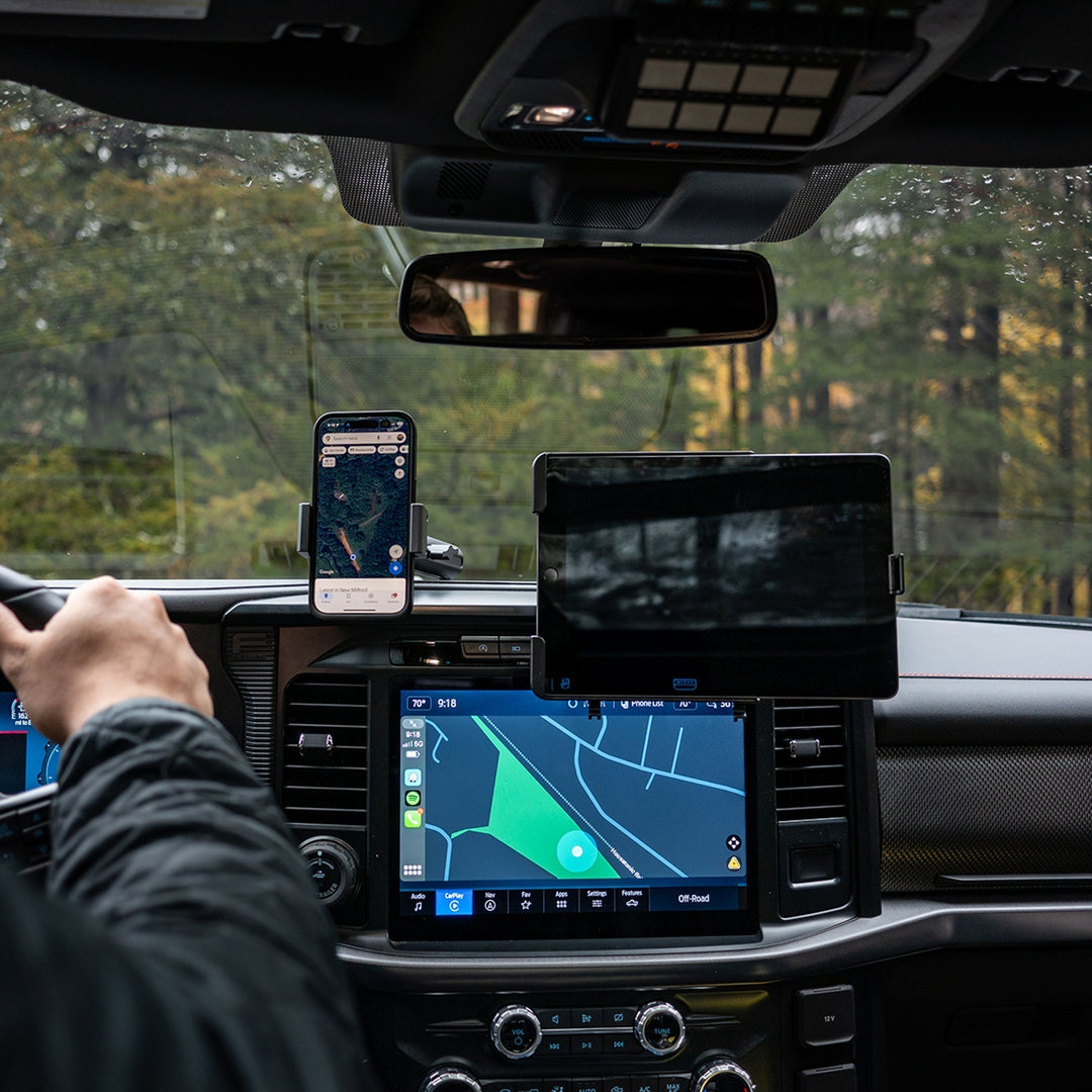 Phone and tablet mounted on the dash below the windshield line in a Ford F-150